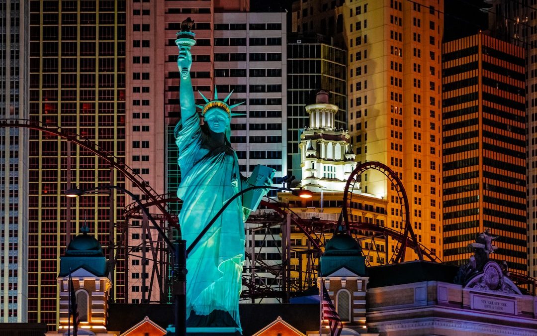 the statue of liberty is lit up at night