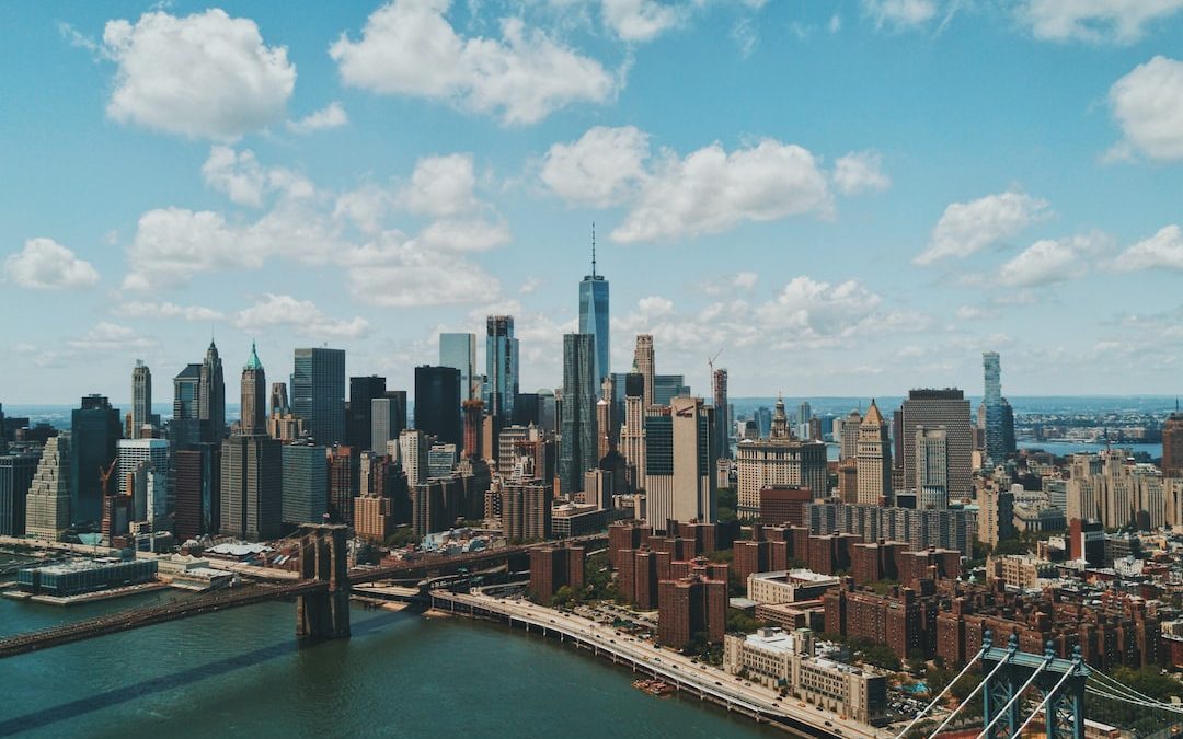 wide angle photo of Brooklyn Bridge under cloudy sky