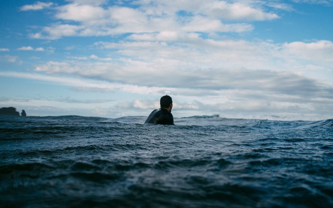 man swimming during day time