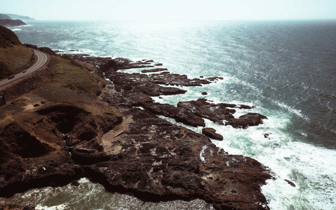an aerial view of a road near the ocean