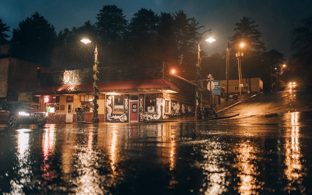 a gas station sitting on the side of a wet road