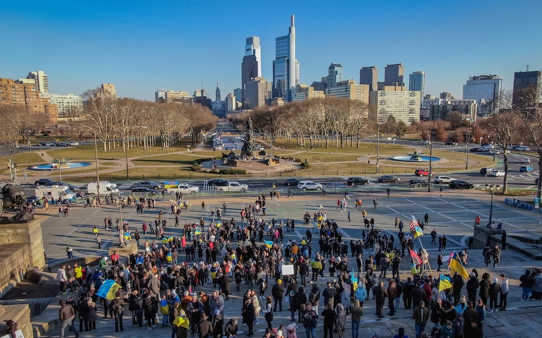 a large group of people standing in a parking lot