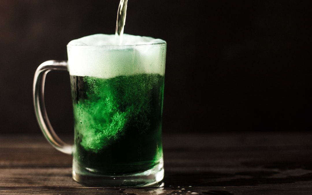 clear glass mug filled with green liquid