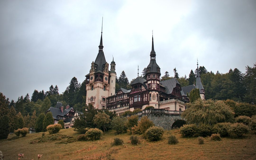 a castle with many spires with Peleș Castle in the background