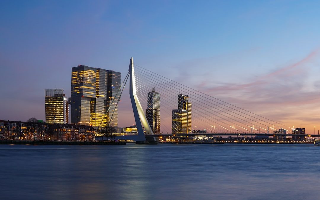 city skyline under blue sky during night time