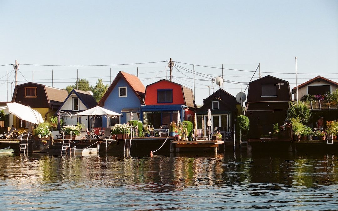 a row of houses sitting on top of a body of water