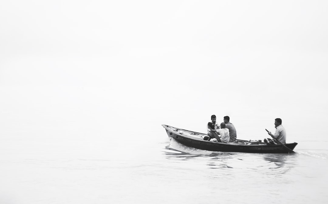 a group of people in a small boat on a body of water